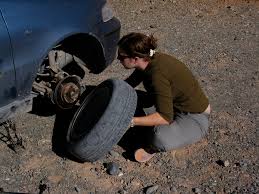 Lady changing car tyre - Attention deficit device addiction disorder 