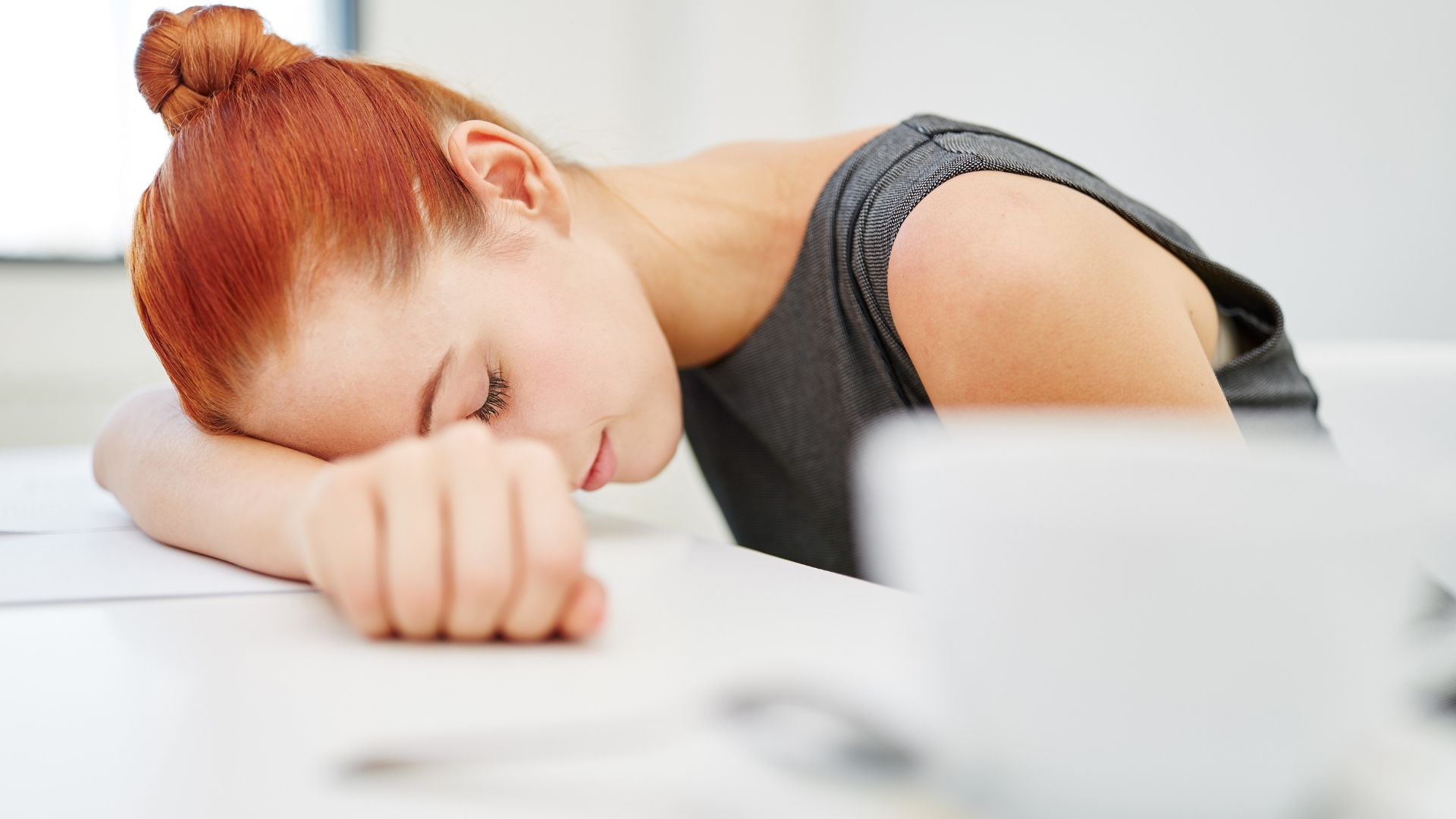 woman sleeping on desk