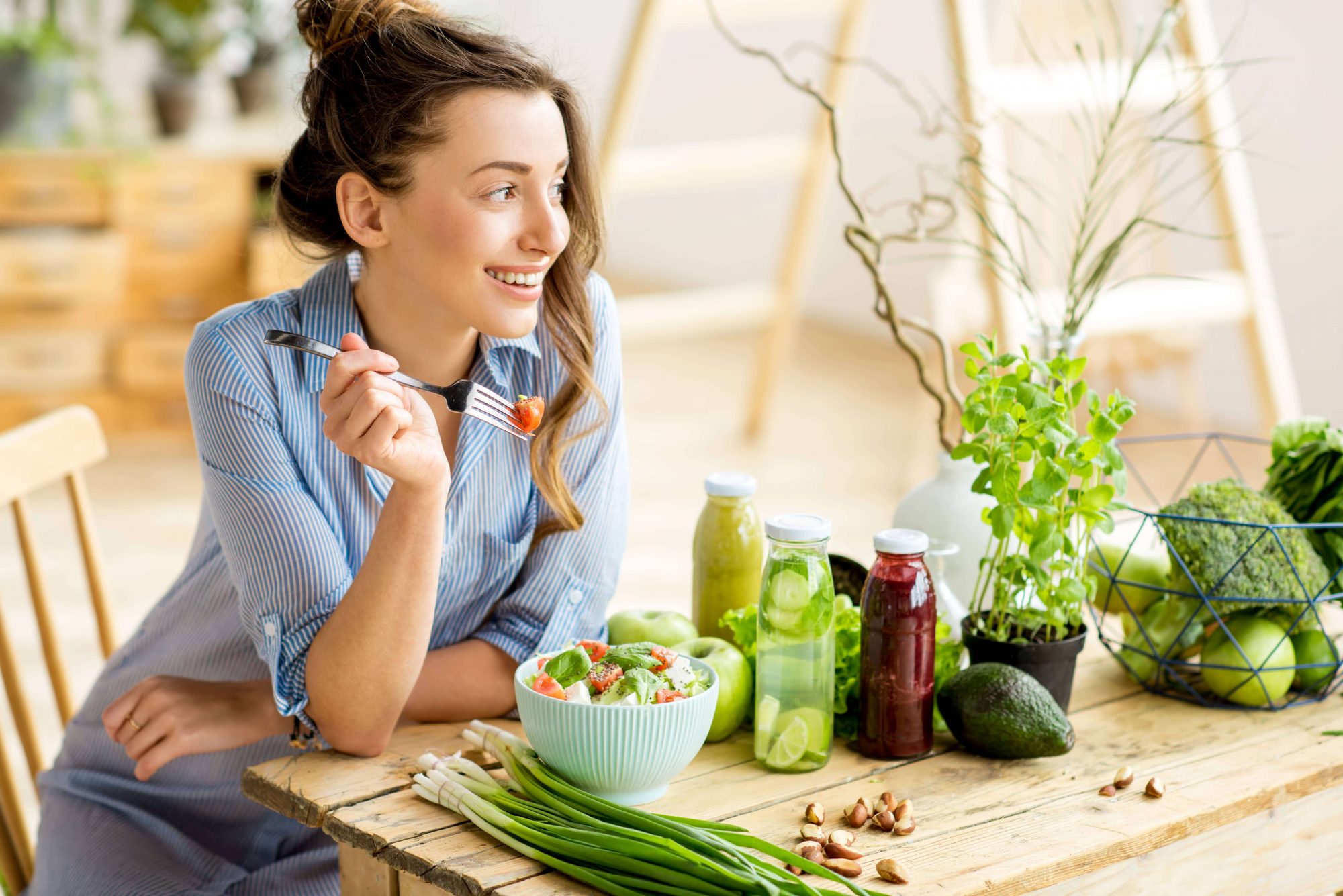 Woman Smiling while eating Vegetables