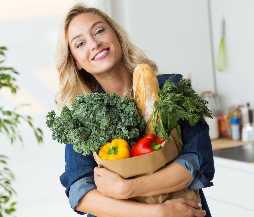 Woman holding a bag of vegetables