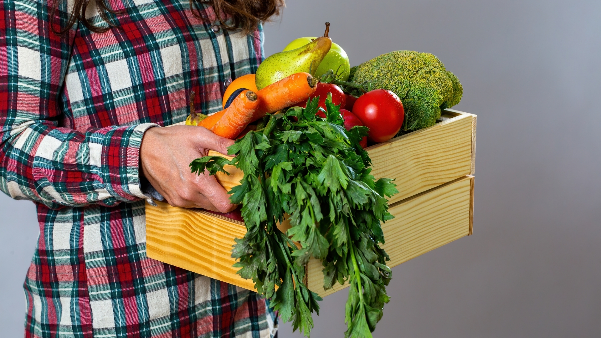 Woman Holding Assorted Vegetables in a Box Woman Holding Assorted Vegetables in a Box