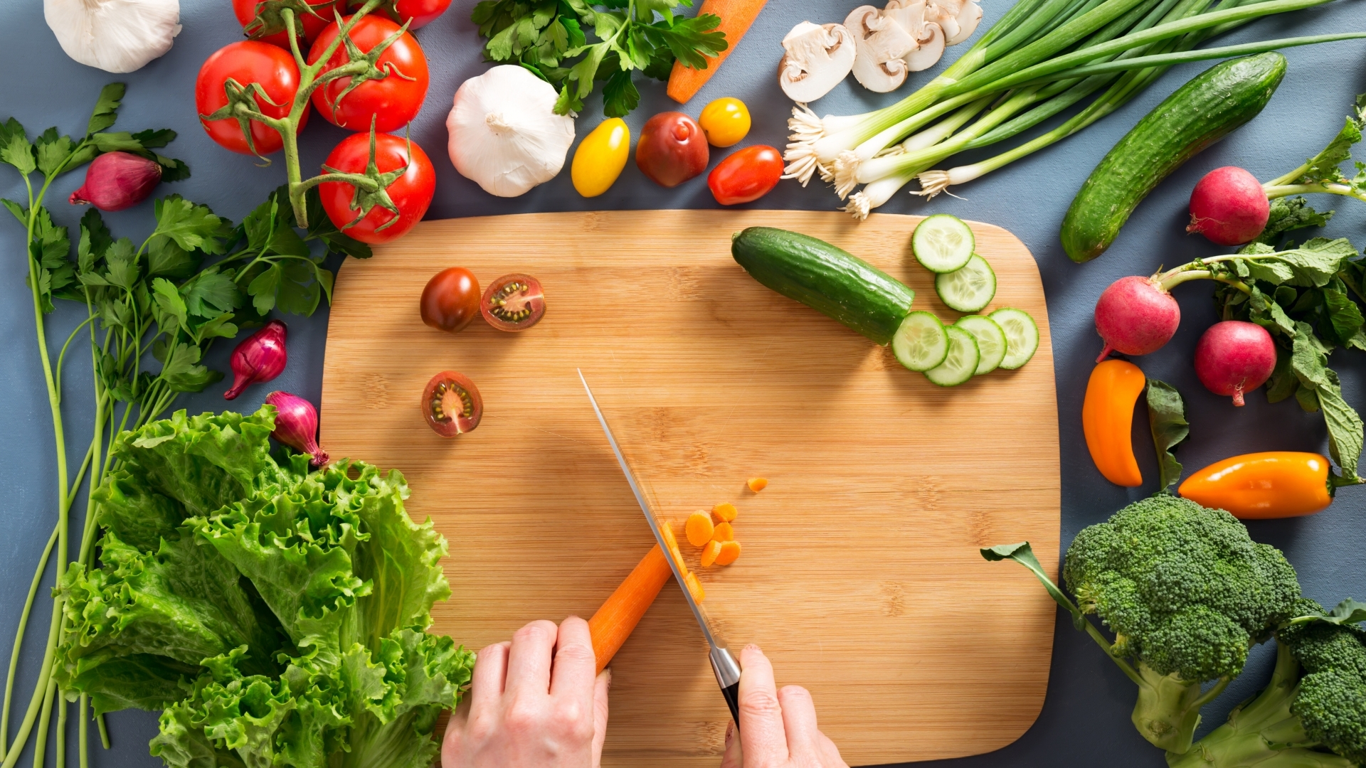 Chopping Carrots Surrounded by Different Vegetables